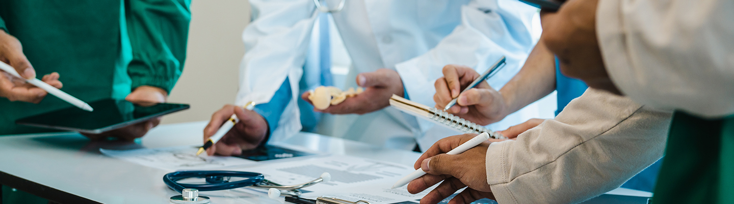 A group of medical providers working on a table.